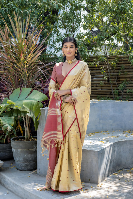 Cream Semi Tussar Silk Saree With All Over Bandhani Style Butti Weaves And Very Well Designed Traditional Temple Border With Zari Linning Pallu And Blouse Piece