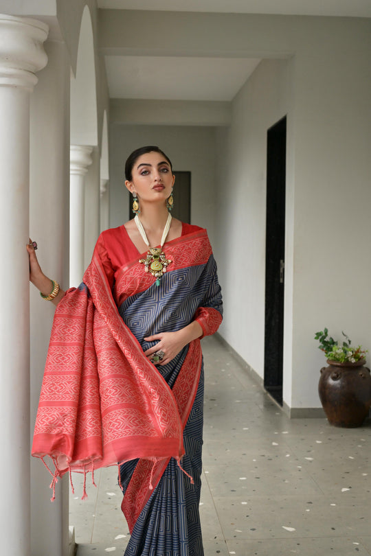 Grey & Red Soft Desi Tussar Silk Saree With Unique Ikkat Painted Pattern With Tradional Ikkat Pallu And Border With Traditional Tassels And Contrast Blouse Piece