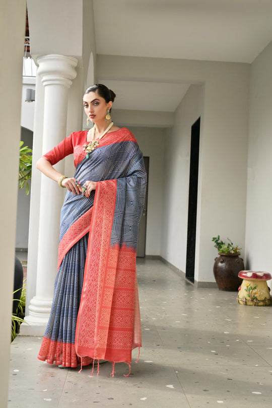 Grey & Red Soft Desi Tussar Silk Saree With Unique Ikkat Painted Pattern With Tradional Ikkat Pallu And Border With Traditional Tassels And Contrast Blouse Piece