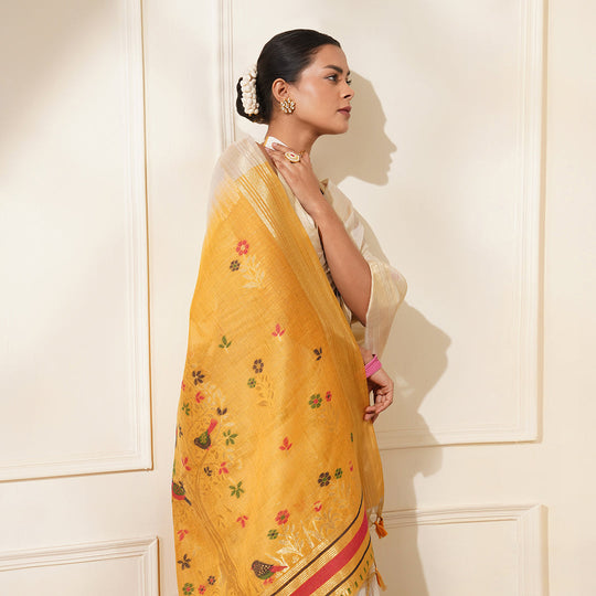 White & Yellow Premium Soft Muga Cotton Saree With Classic Colorful Resham Weaving Pallu And Traditional Zari Weaving Border And All Over Resham Weaving Butties And Fancy Tassels With Contrast Blouse Piece