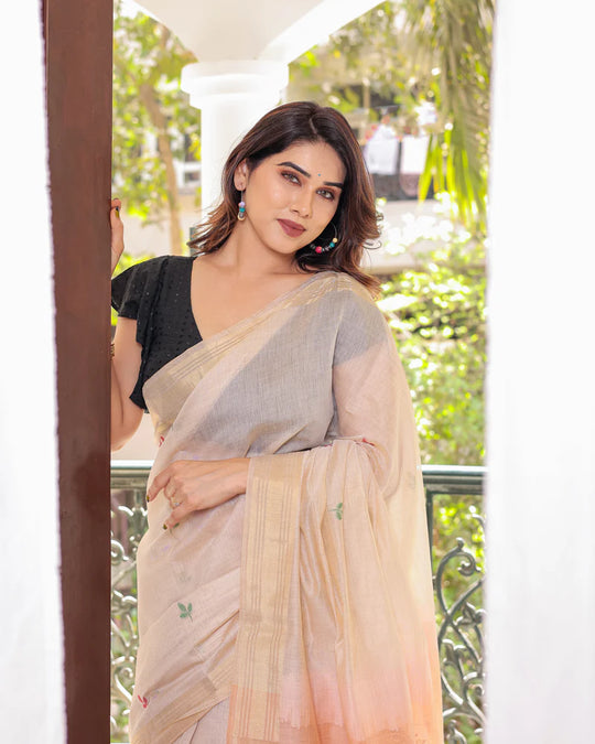 Off White & Peach Premium Soft Muga Cotton Saree With Classic Colorful Resham Weaving Pallu And Traditional Zari Weaving Border And All Over Resham Weaving Butties And Fancy Tassels With Contrast Blouse Piece