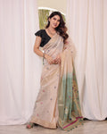 Off White & Green Premium Soft Muga Cotton Saree With Classic Colorful Resham Weaving Pallu And Traditional Zari Weaving Border And All Over Resham Weaving Butties And Fancy Tassels With Contrast Blouse Piece